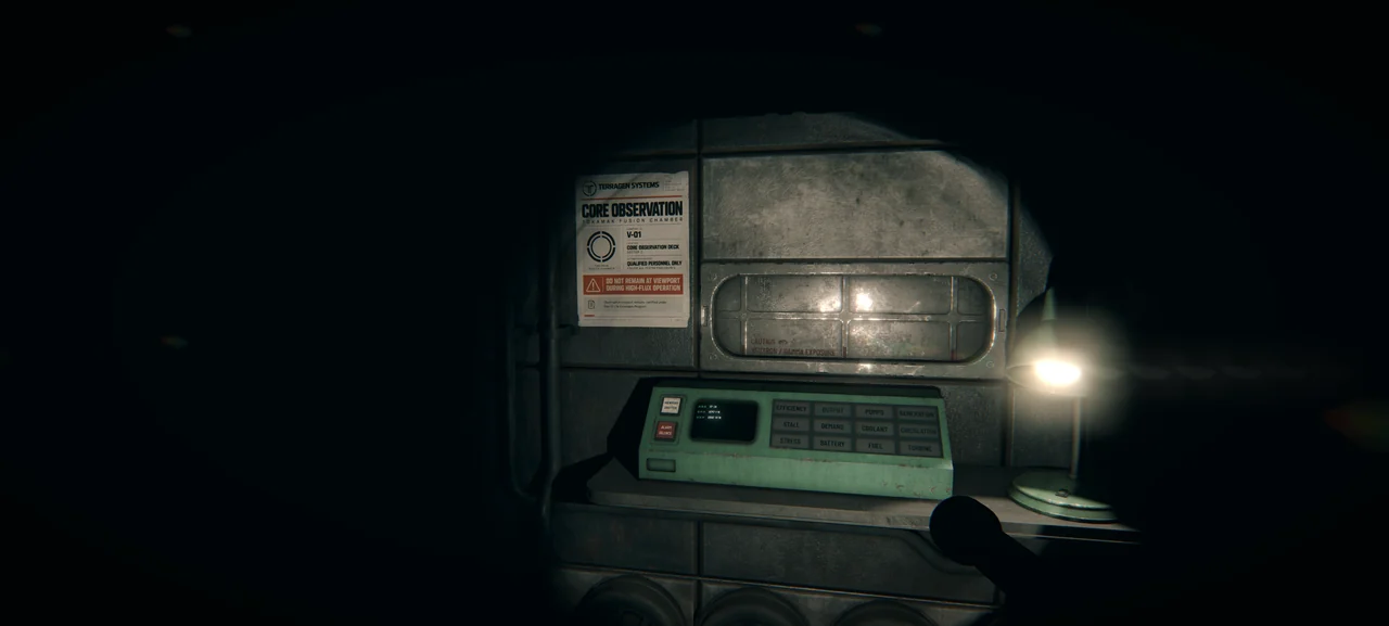 A flashlight illuminates the observation console in the dark.
